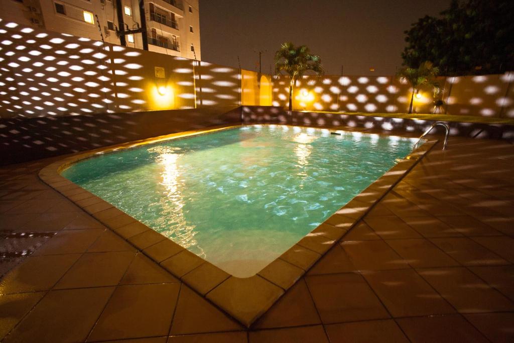 Mamle's Retreat shared pool lit at night in East Legon, Accra