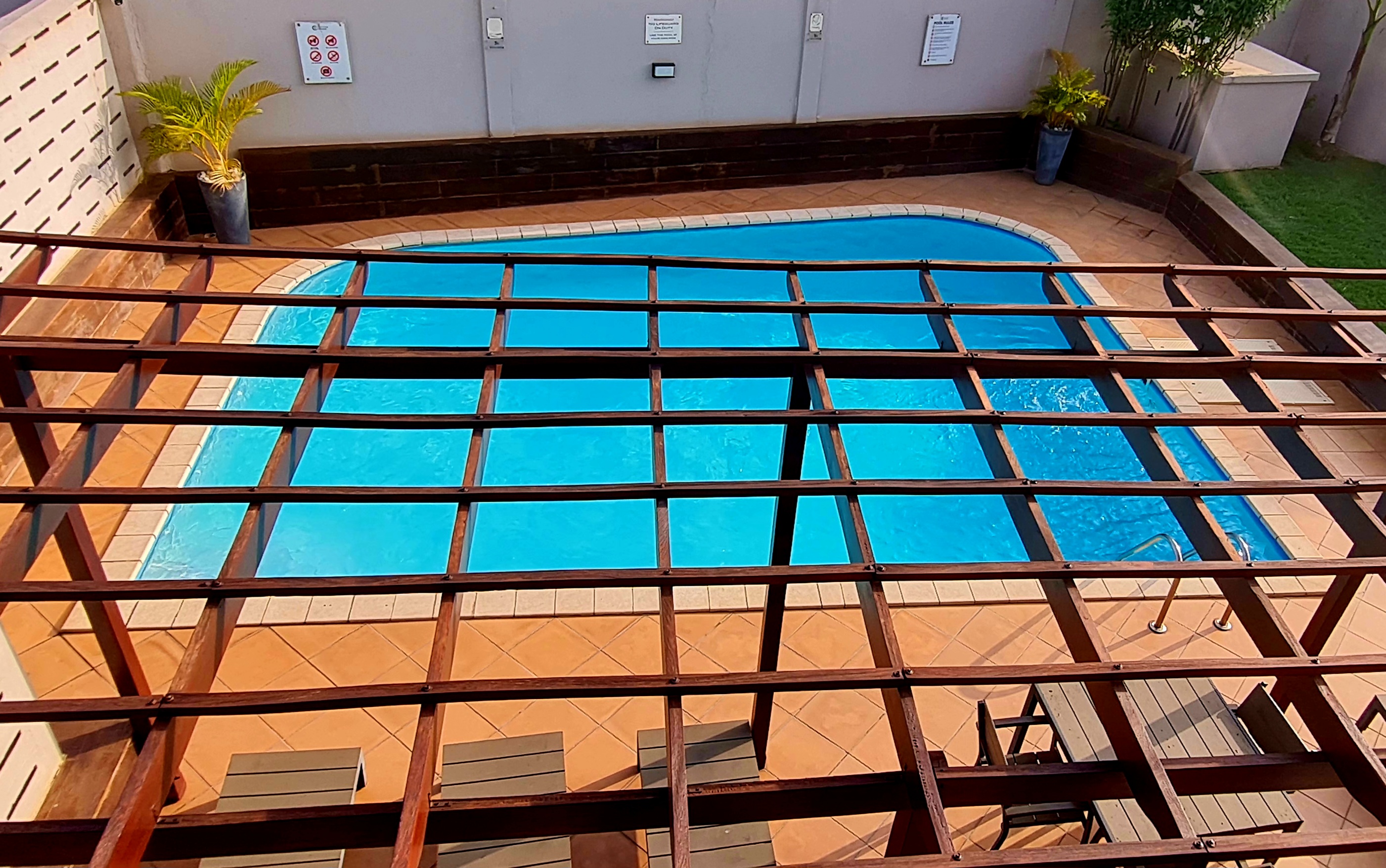 Daytime balcony view over the shared pool at Mamle's Retreat in Accra